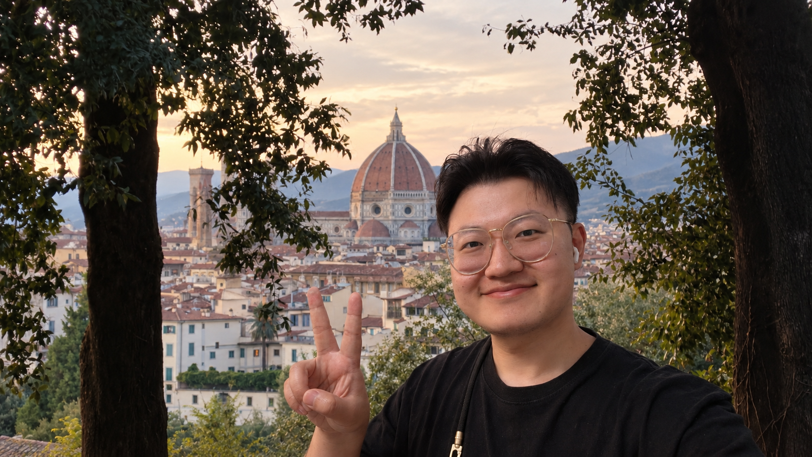 Portrait of Yiwei Li with the city and a dome in the evening light.